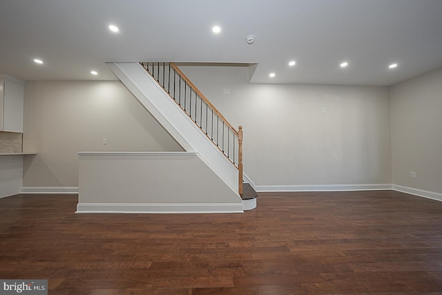 staircase with hardwood / wood-style flooring