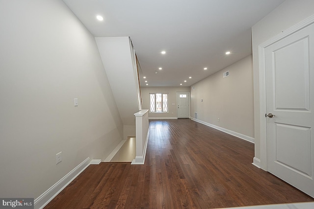 unfurnished living room featuring dark wood-type flooring