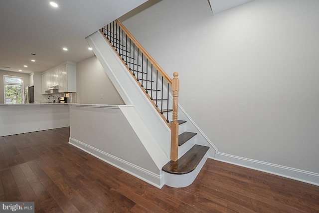 staircase featuring hardwood / wood-style floors