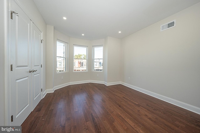 spare room featuring dark hardwood / wood-style flooring