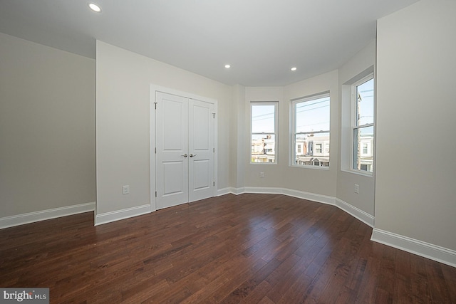 unfurnished bedroom with dark hardwood / wood-style floors