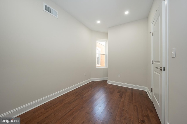 spare room with dark wood-type flooring