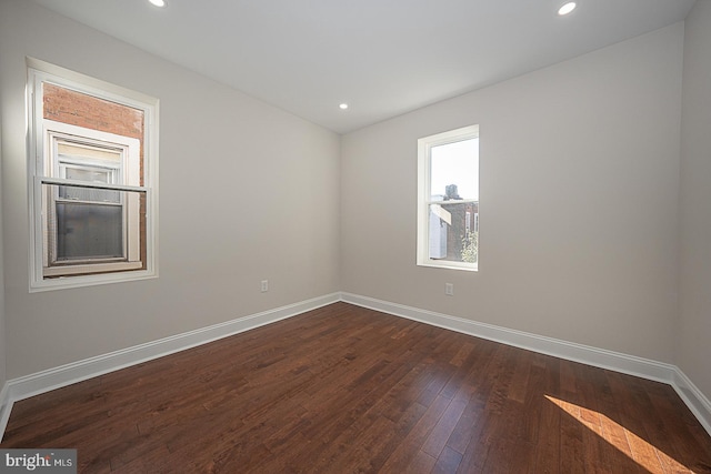 spare room with dark wood-type flooring