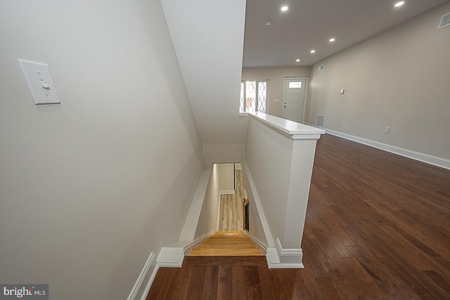 staircase with hardwood / wood-style floors