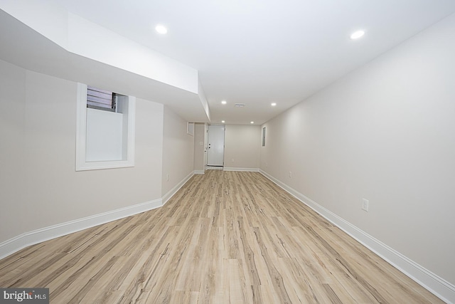 basement with light hardwood / wood-style flooring