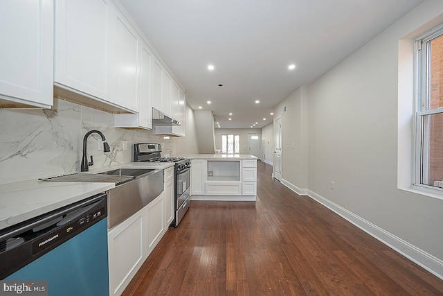 kitchen with tasteful backsplash, kitchen peninsula, white cabinetry, stainless steel appliances, and dark wood-type flooring