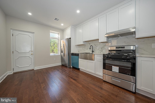 kitchen featuring extractor fan, white cabinets, stainless steel appliances, and sink