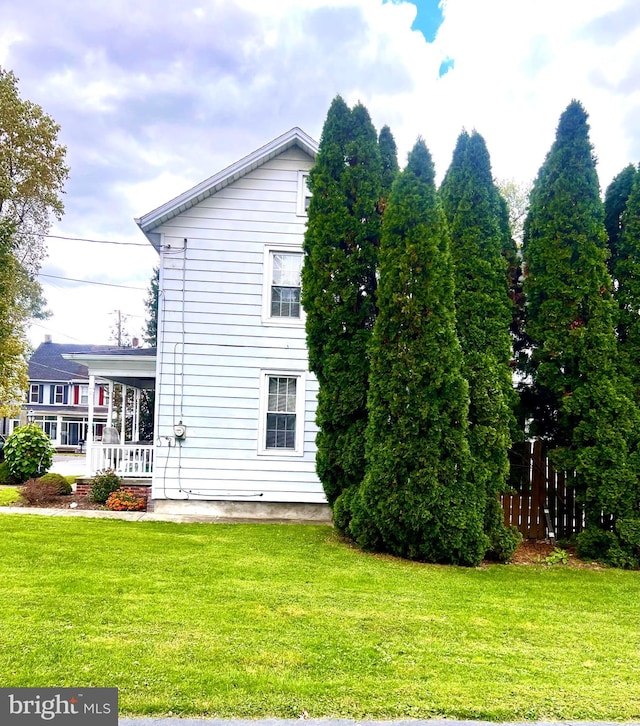 view of side of property with a yard