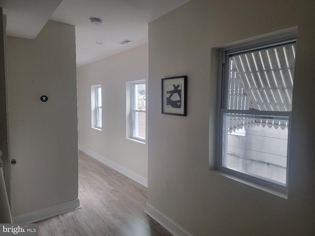 hallway with light hardwood / wood-style flooring