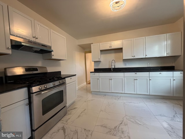 kitchen with stainless steel gas range, sink, and white cabinets