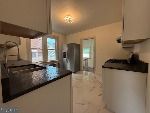 kitchen with sink, radiator, stainless steel appliances, and plenty of natural light