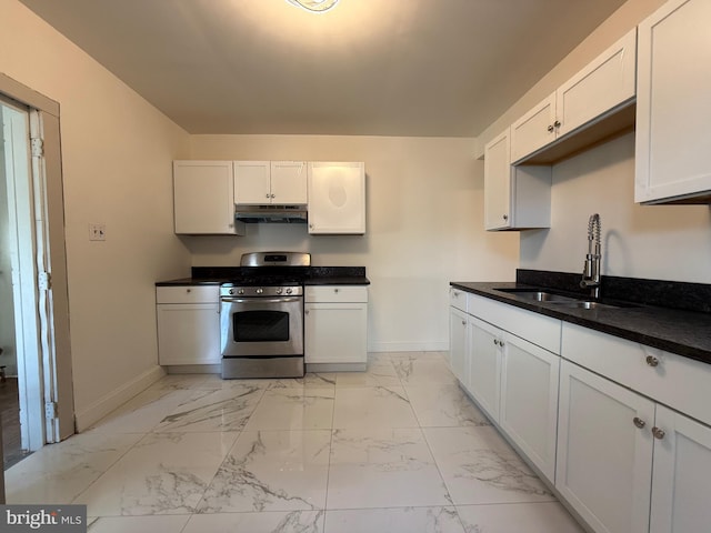 kitchen featuring sink, white cabinets, dark stone countertops, and gas range