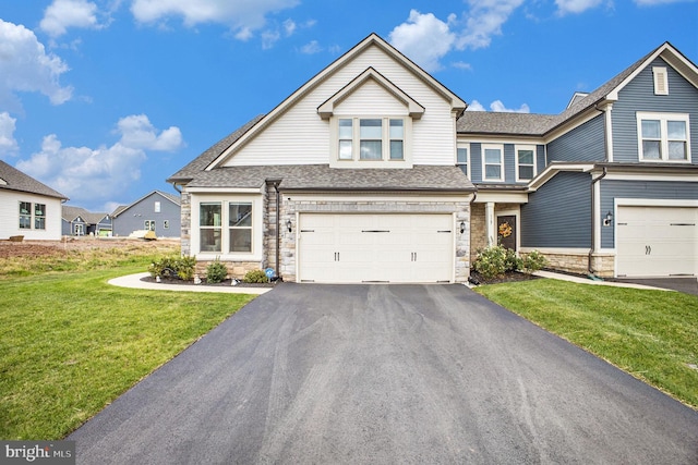 view of front of property featuring a front yard and a garage