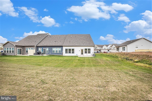 back of property featuring a yard and a patio area