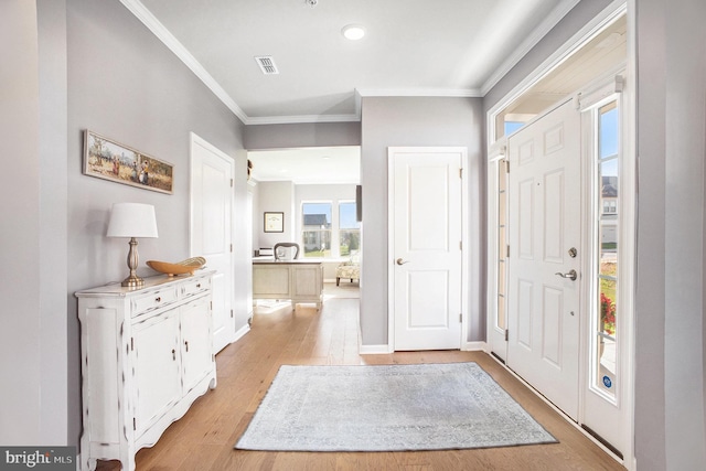 entryway featuring crown molding and light hardwood / wood-style flooring