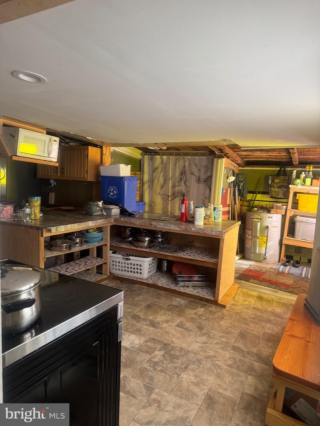 interior space featuring electric water heater and stainless steel stove