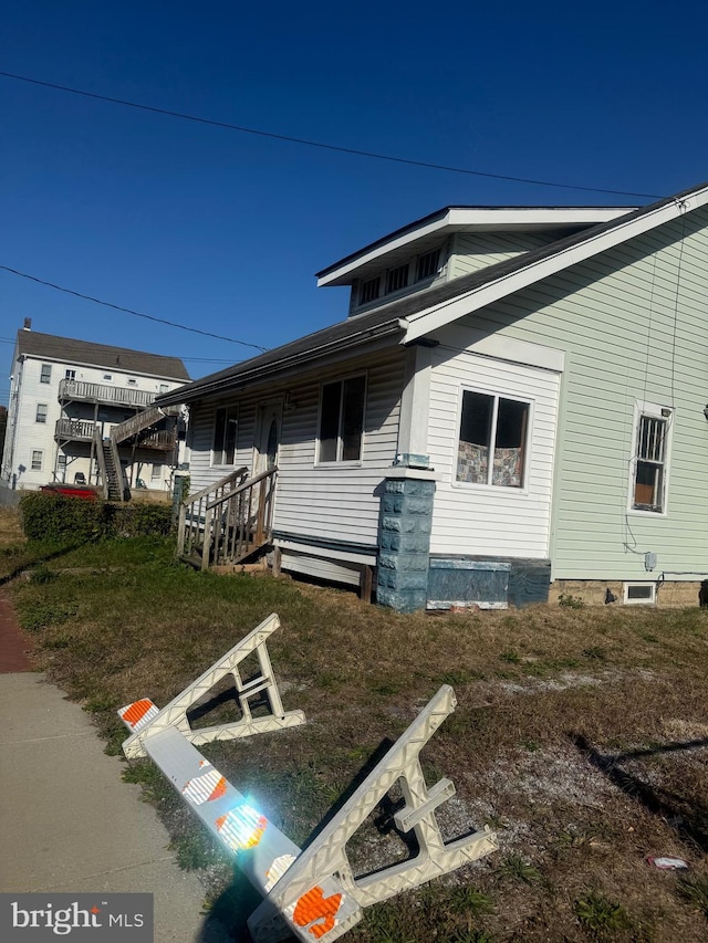 view of side of home with a yard