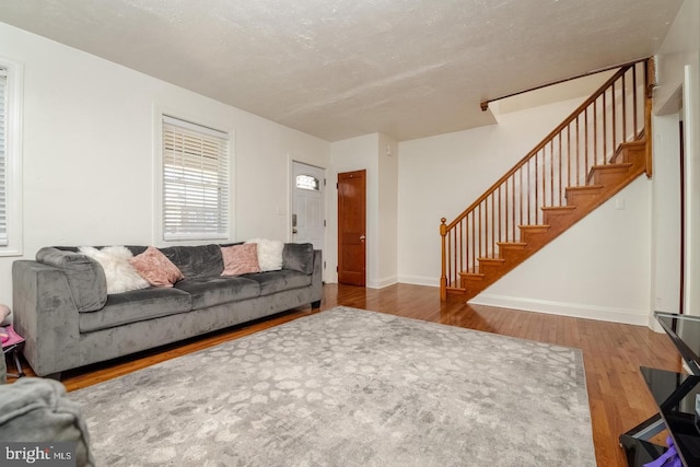 living room with hardwood / wood-style flooring and a textured ceiling