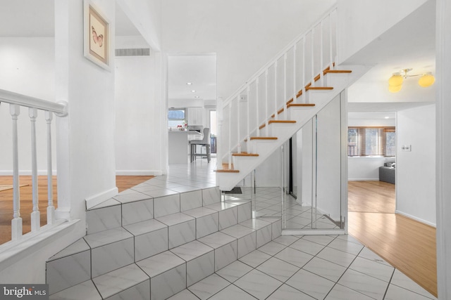 staircase featuring wood-type flooring