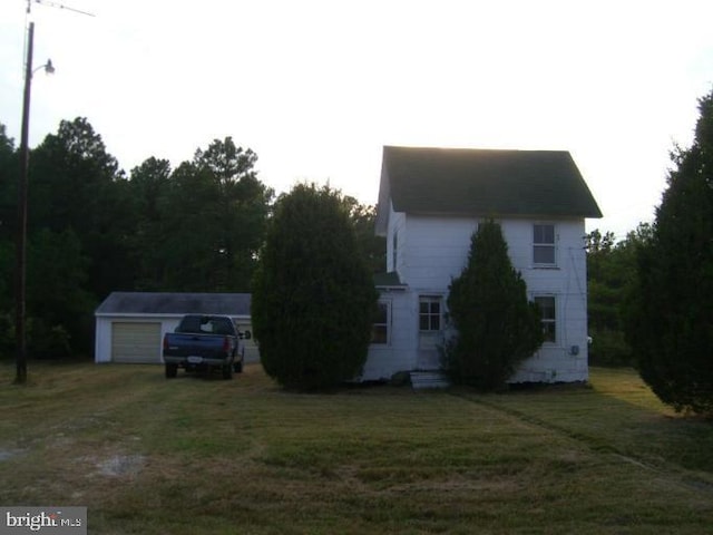 view of property exterior with a yard, an outbuilding, and a garage