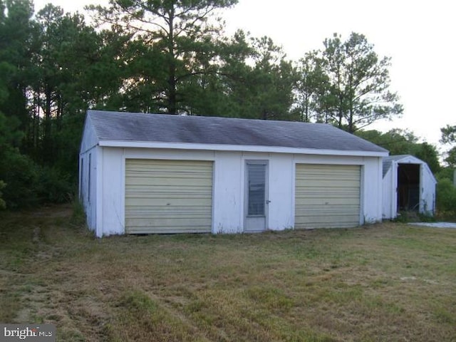 garage featuring a lawn