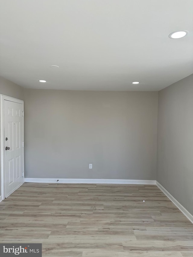 unfurnished room with light hardwood / wood-style flooring