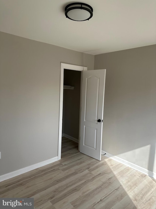 empty room with light hardwood / wood-style floors