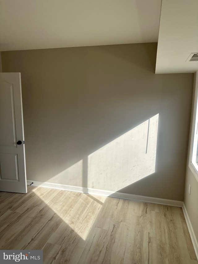 unfurnished room with light wood-type flooring