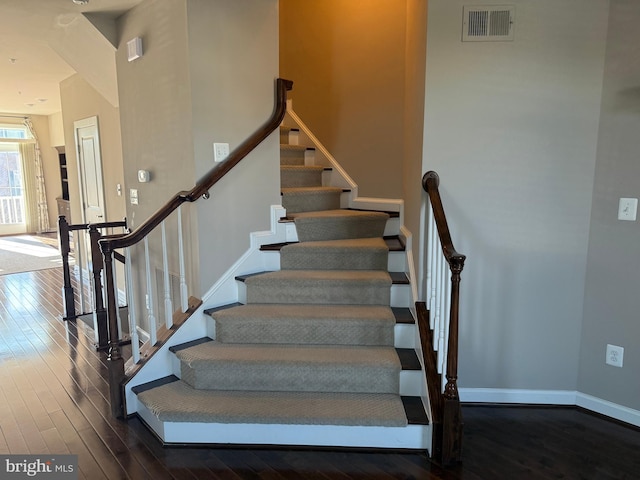 stairway with hardwood / wood-style flooring