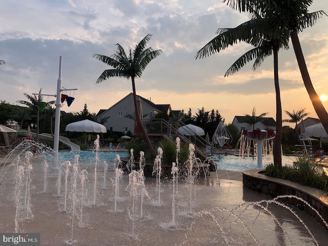 view of pool at dusk