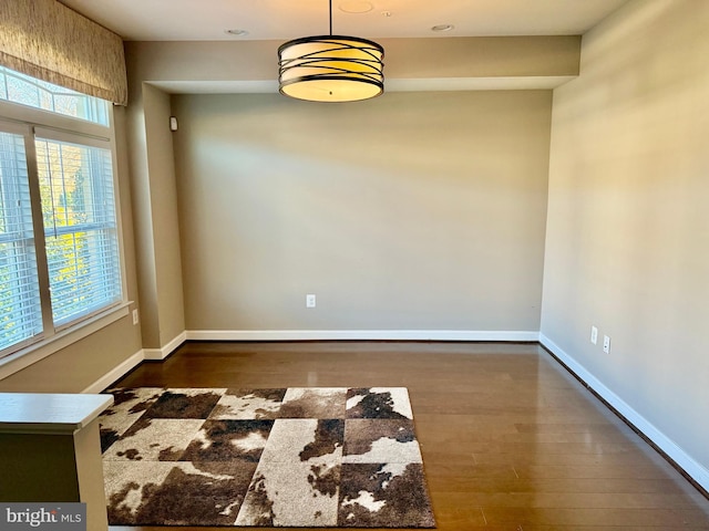 spare room with dark wood-type flooring