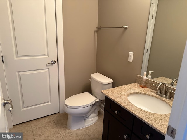 bathroom with tile patterned floors, vanity, and toilet