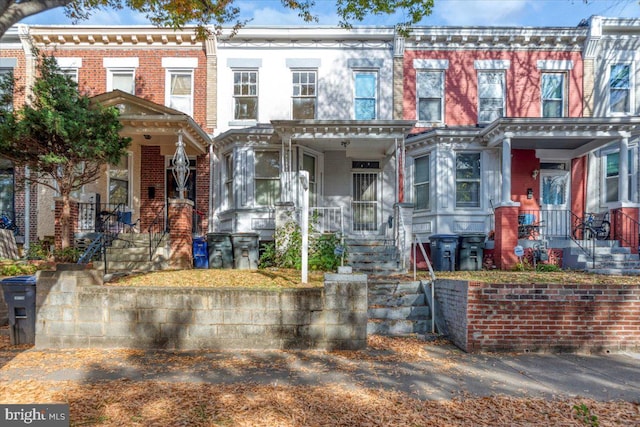 townhome / multi-family property featuring a porch