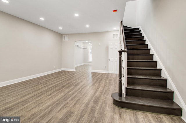 stairs featuring hardwood / wood-style flooring