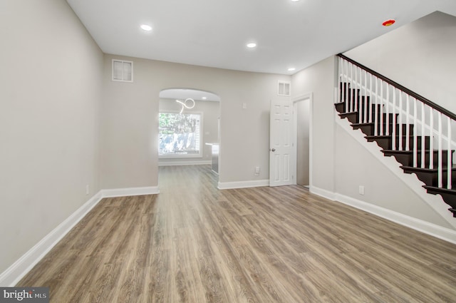 unfurnished living room featuring hardwood / wood-style floors