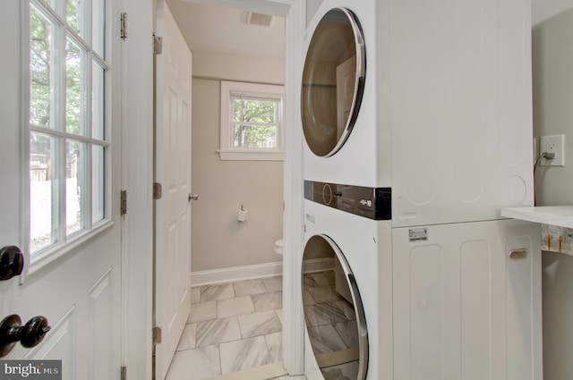 laundry area with stacked washer / dryer