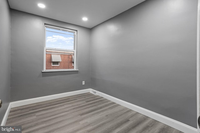 empty room with hardwood / wood-style flooring