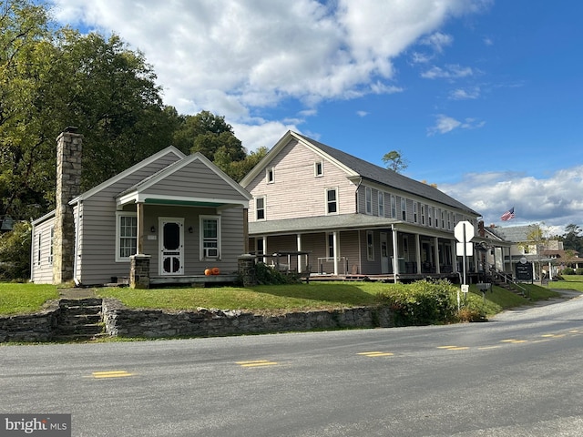 view of front of property with a front yard and a porch