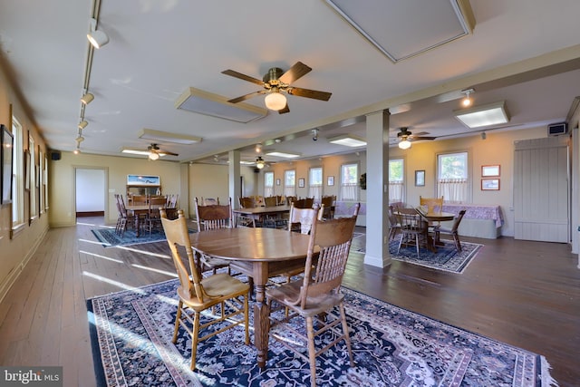 dining room with hardwood / wood-style flooring and track lighting