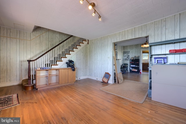 interior space featuring wooden walls and wood-type flooring