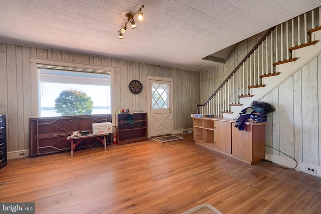 foyer featuring wooden walls and wood-type flooring