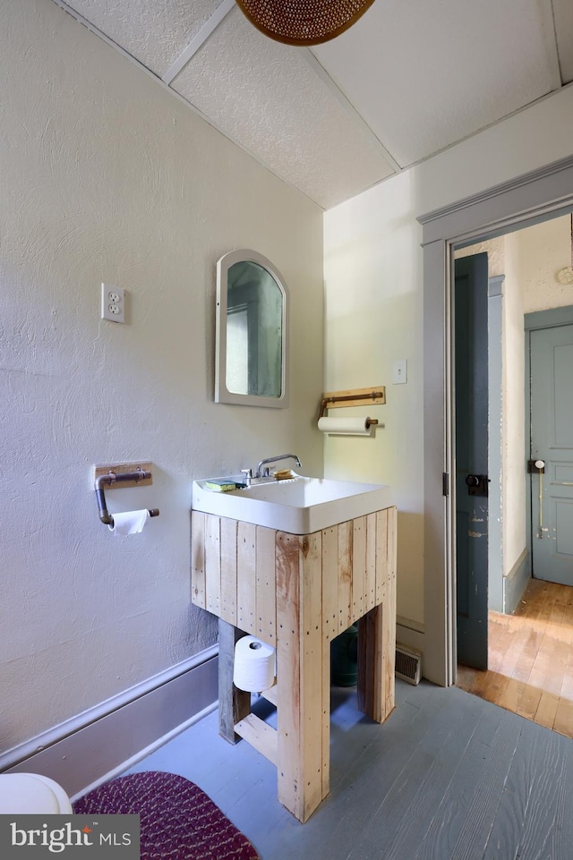 bathroom featuring vanity, hardwood / wood-style flooring, and toilet