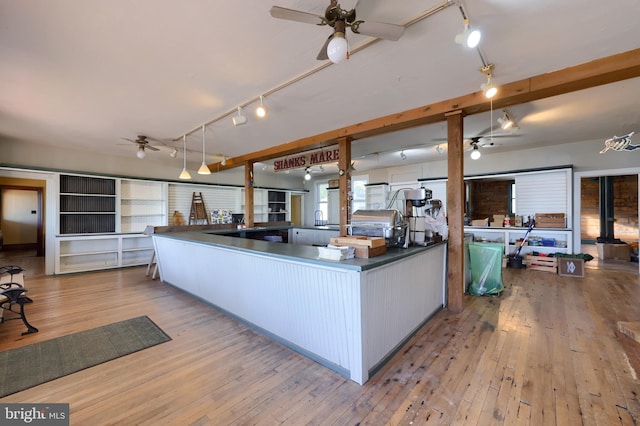 kitchen with sink, white cabinets, and light wood-type flooring