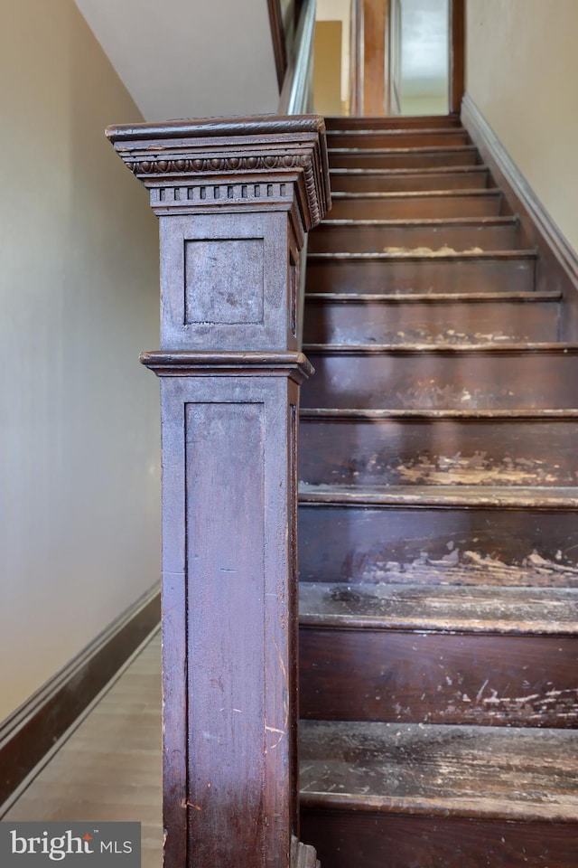 stairway with hardwood / wood-style floors