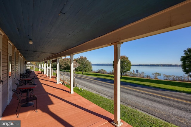 wooden terrace featuring a water view