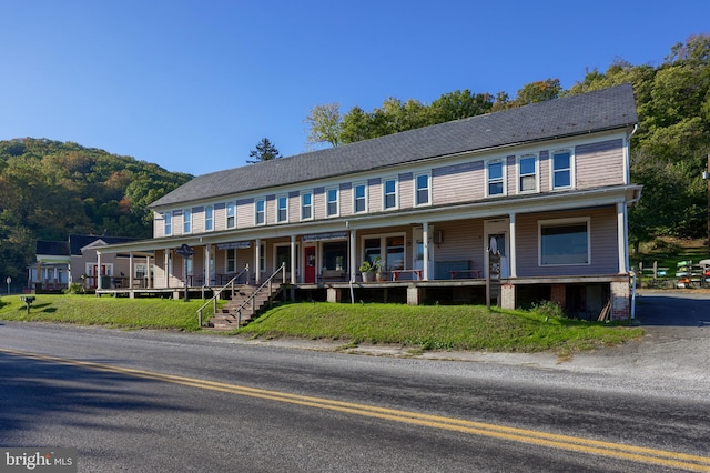 view of front of house featuring covered porch and a mountain view