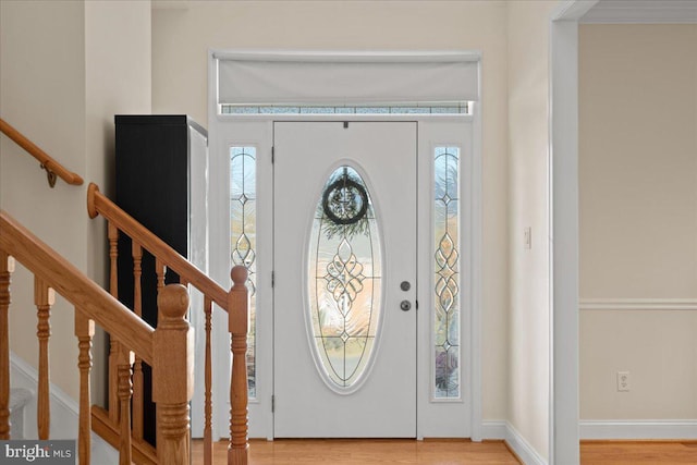 entryway featuring hardwood / wood-style floors and ornamental molding