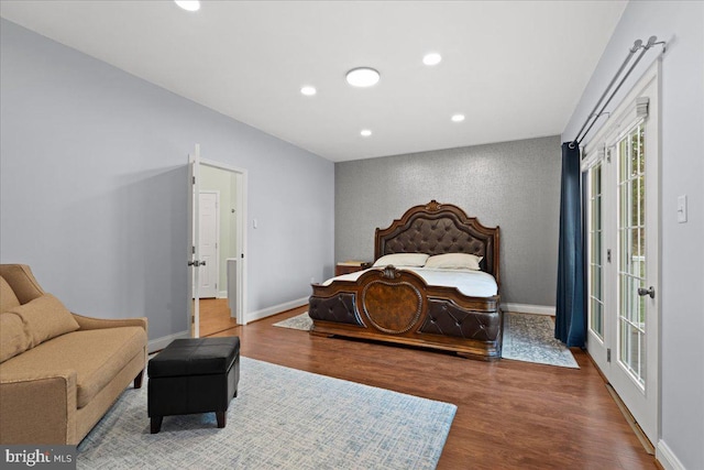 bedroom featuring wood-type flooring and access to outside