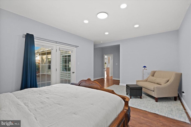 bedroom featuring hardwood / wood-style floors and access to outside