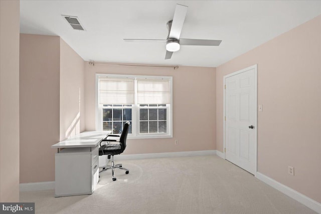 unfurnished office featuring light carpet and ceiling fan